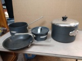 Three pots and one pan labeled calphalon