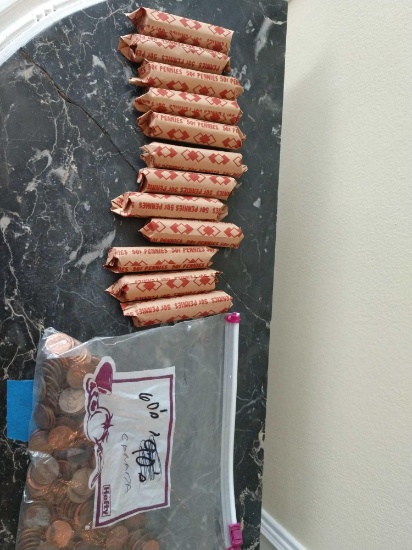 Rolled pennies and a bag of pennies