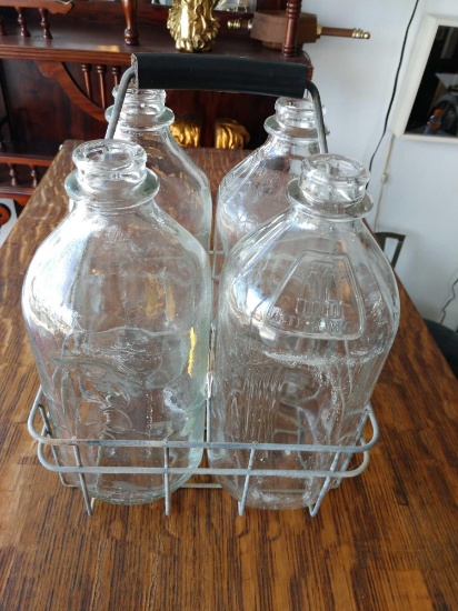 4 Sterling milk bottles with carrier