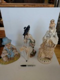 Three ceramic figurines various heights
