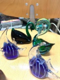 Glass swans and fish paperweights