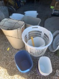 Lots of assorted trash cans plungers laundry