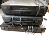 Two VHS players and one DVD player