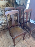 Four matching wooden chairs