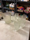 Six clear glass drinking glasses with matching water pitcher