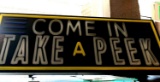 Come and take a peek lighted sign