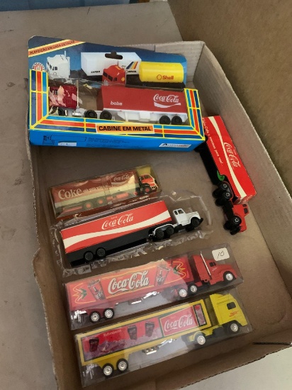 Six Coca-Cola collectible semi trucks