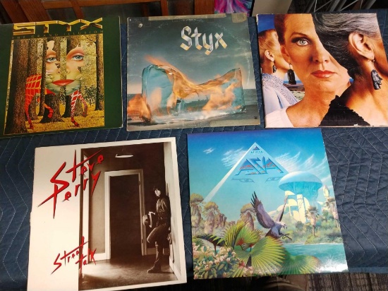 Five record albums including Styx, Steve Perry, and Asia