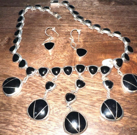 heavy silver necklace and earrings
