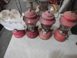 four red Coleman lanterns