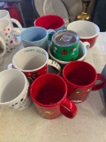 9 snoopy Christmas mugs
