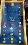 large framed collage of military pins 1954 through 1984