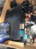 two PlayStation 2 systems, five controllers, memory cards, tables,