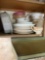 Bottom shelf of kitchen cabinet some Corelle dishes and more