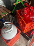 Gas tanks, propane tank, and crates in shed