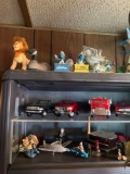 3 shelves of knickknacks cars, planes, Smurfs