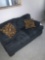 Blue loveseat with pillows -C Bedroom