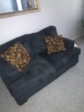 Blue loveseat with pillows -C Bedroom
