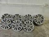four 18 inch Cadillac rims with covers.g5