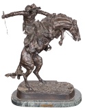 After Frederic Remington (American, 1861-1909) 'The Bronco Buster' Patinated Bronze Sculpture