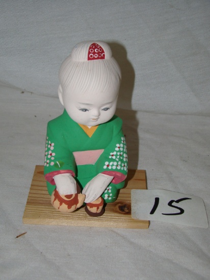 JAPAN GENUINE HAKATA DOLL, CHILD WITH TEA POT WITH BASE. 5-1/2"