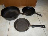 Old fashioned grinder and three skillets