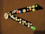 Display of pins on black ribbons