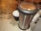 Tall metal waste can and bathroom items