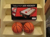 Tabletop air hockey and basketballs