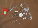 Silver colored necklaces and brooches