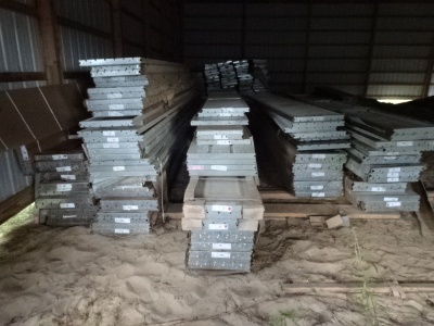 Large quantity of insulated and non-insulated metal garage overhead door panels
