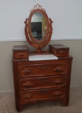 Ornate fruit carved walnut dresser with marble inset and mirror