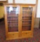 Beautiful maple two door bookcase with two drop down doors and carving