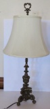 Ornate metal table lamp with faces and clawfeet