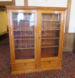 Beautiful maple two door bookcase with two drop down doors and carving