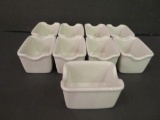 Nine sugar packet holders, white china