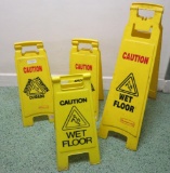 Four floor standing CAUTION Wet Floor signs