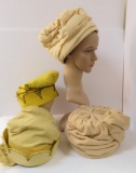 Three ivory and yellow hats