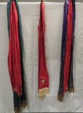 Five ornate scarves, four with metal fringe