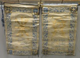 Two painted banners on wooden rods