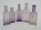 Five vintage extract and cream bottles, violet