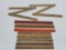Nine wooden advertising rulers