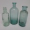 Three old medicine bottles
