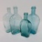 Four blue green flask bottles