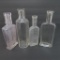Four clear medicine bottles