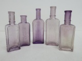 Five vintage extract and cream bottles, violet