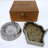 Two industrial metal advertising ashtrays and wooden cigar box