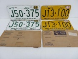 Two matching sets of Wisconsin license plates with envelopes, 1956 and 1958