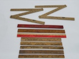 Nine wooden advertising rulers