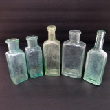 Five small medicine bottles, 5